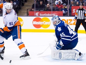 Maple Leafs goalie Jonathan Bernier, right, stops New York Islanders forward John Tavares during the first period on Tuesday, January 7, 2014. (THE CANADIAN PRESS/Nathan Denette)