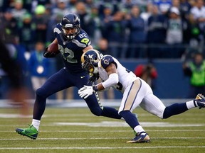 LaSalle's Luke Willson, left, of the Seattle Seahawks runs around by St. Louis' Rodney McLeod at CenturyLink Field in Seattle.  (Photo by Jonathan Ferrey/Getty Images)