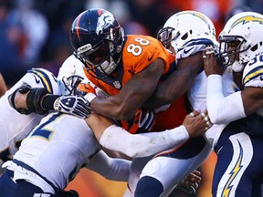 Denver's Demaryius Thoma, centre, fights for a first down against the San Diego during the AFC Divisional Playoff game at Mile High on January 12, 2014 in Denver.  (Doug Pensinger/Getty Images)