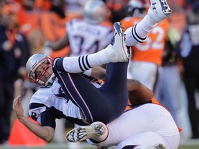 New England QB Tom Brady, left, is sacked by Denver's Terrance Knighton during the AFC Championship in Denver, Sunday, Jan. 19, 2014. The Broncos won 26-16. (AP Photo/Joe Mahoney)