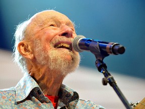 his Sept. 21, 2013, file photo shows Pete Seeger performing on stage during the Farm Aid 2013 concert at Saratoga Performing Arts Center in Saratoga Springs, N.Y.   The American troubadour, folk singer and activist Seeger  died Monday Jan. 27, 2014, at age 94.  (AP Photo/Hans Pennink, File)