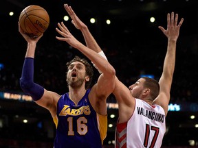 Lakers centre Pau Gasol, left,  drives to the basket against Toronto's Jonas Valanciunas during first half NBA action in Toronto on Sunday January 19, 2014. (THE CANADIAN PRESS/Frank Gunn)