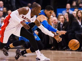 Orlando's Tobias Harris, right, reaches for a lost ball against Toronto's Terrence Ross in Toronto on Wednesday, January 29 2014. (THE CANADIAN PRESS/Aaron Vincent Elkaim)