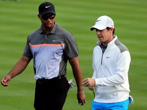Tiger Woods, left, talks to Rory McIlroy during the first round of the Dubai Desert Classic in Dubai, United Arab Emirates, Thursday, Jan. 30, 2014. (AP Photo)