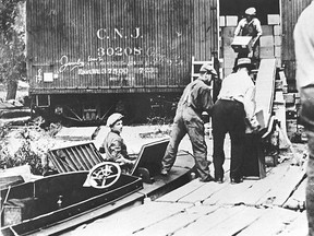 Rum runners load up a speedboat from an export dock on the Canadian side of the Detroit River in this undated file photo.