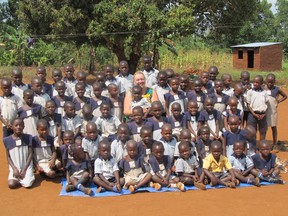 Retired Essex County teacher Geri Sutts,  founder of the Canadian chapter of Save African Child Uganda (SACU), sits with some of "her children" in a village called Buwundo, in Uganda near Jinja. (Submitted Photo)