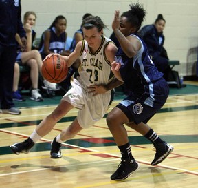 St. Clair's Jaide Lyons, left, cuts around Sheridan's Shylanda Saunders at St. Clair College in Windsor on Friday, January 24, 2013.                           (TYLER BROWNBRIDGE/The Windsor Star)