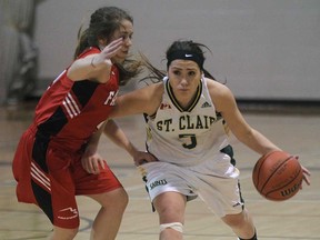 Fanshawe's Kiera Serodio, left, pressures St. Clair's Sarah Bondy during OCAA basketball action Wed. Jan. 15, 2014, in Windsor. (DAN JANISSE/The Windsor Star)