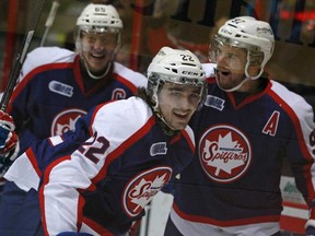 Windsor's Sam Povorozniouk, centre, celebrates with teammates, Slater Koekkoek, left, and Brady Vail after scoring the opening goal against the Sudbury Wolves at the WFCU Centre, Sunday, Jan. 19, 2014.  Windsor defeated Sudbury 3-1. (DAX MELMER/The Windsor Star)