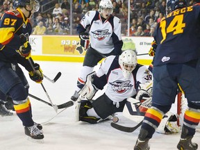 Spitfires defenceman Patrick Sanvido, centre,  and goalkeeper Alex Fotinos defend the goal against Erie's Connor McDavid , left, and Brendan Gaunce during OHL action in Erie, Pa., on Jan. 12.  Erie won 9-0. (ANDY COLWELL/Erie Times-News)