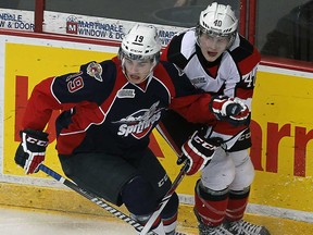 Windsor's Ryan Foss, left, and the Ottawa's Alex Lintuniemi battle for the puck at the WFCU Centre in Windsor  on Thursday, January 9, 2013. (TYLER BROWNBRIDGE/The Windsor Star)
