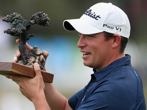 Scott Stallings celebrates with the trophy after winning the Farmers Insurance Open at Torrey Pines Golf Course on January 26, 2014 in La Jolla, California. (Todd Warshaw/Getty Images)