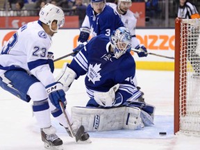 Maple Leafs goalie Jonathan Bernier, right, makes a save as Tampa Bay's J.T. Brown (23) looks for a rebound in Toronto Tuesday, January 28, 2014. (THE CANADIAN PRESS/Frank Gunn)