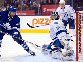 Toronto's Nazem Kadri, left, scores his second goal of the game on Tampa Bay goaltender Ben Bishop in Toronto on Tuesday January 28, 2014. (THE CANADIAN PRESS/Frank Gunn)