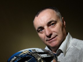 Lou Tortola shows off his latest invention: speakers that attach to a bike helmet.  (TYLER BROWNBRIDGE/The Windsor Star)