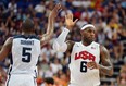 Forward Kevin Durant, left, celebrates with LeBron James during the 2012  London Olympic Games against Spain.  Durant and James were named to Team USA's roster for the World Cup this summer. (MARK RALSTON/AFP/Getty Images)