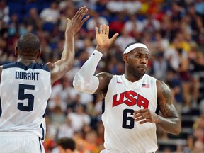 Forward Kevin Durant, left, celebrates with LeBron James during the 2012  London Olympic Games against Spain.  Durant and James were named to Team USA's roster for the World Cup this summer. (MARK RALSTON/AFP/Getty Images)