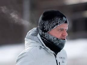 A jogger runs along the bank of the Rideau Canal Tuesday January 21, 2014 in Ottawa. (THE CANADIAN PRESS/Adrian Wyld)