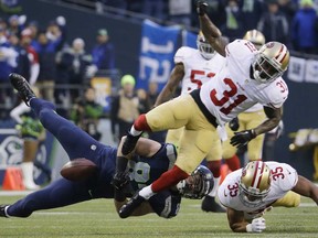 LaSalle's Luke Willson, left, loses the ball after a hit by San Francisco's Donte Whitner during the NFC Championship Sunday, Jan. 19, 2014, in Seattle. (AP Photo/Ted S. Warren)