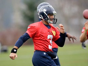 Seattle QB Russell Wilson runs through a drill during practice Thursday, Jan. 16, 2014, in Renton, Wash. The Seahawks host the San Francisco 49ers on Sunday in the NFC championship game. (AP Photo/Elaine Thompson)