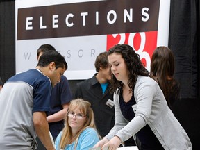 Election officials help voters at a polling station during the October 2010 municipal election. (Nick Brancaccio / The Windsor Star)