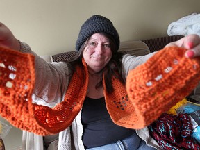 Lori Grondin is one of the organizers of Windsor's Warming Crew, a group of crafters who make handmade mitts, scarves and hats and leave them in public places for people in need. She displays some of her handiwork at her Windsor, Ont. home on Friday, Jan. 24, 2014.  (DAN JANISSE/The Windsor Star)