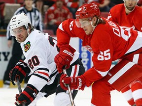 Detroit's Danny DeKeyser, right, steals the puck from Chicago's Brandon Saad Wednesday, Jan. 22, 2014, in Detroit. (AP Photo/Paul Sancya)