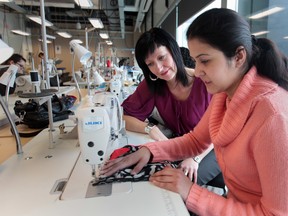 Elaine Chatwood, left,  a co-ordinator with the St. Clair College's new fashion design technician program,  instructs student Nida Mehdi during class this week. (JASON KRYK / The Windsor Star)