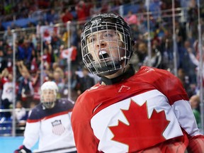 Meghan Agosta-Marciano of Canada scores Canada's third goal on Jessie Vetter of USA during third period action of the preliminary round in the Sochi 2014 Olympic Games, February 12, 2014. Photo by Jean Levac/Postmedia Olympic Team