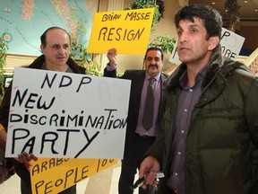 Helmi Charif, former NDP candidate, holds a demonstration Saturday alleging the riding association discriminates against minorities. (Dax Melmer/The Windsor Star)