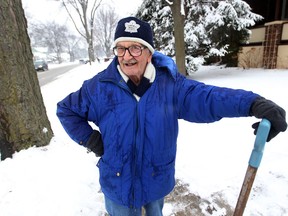 A spry Ted Bounsell, retired University of Windsor professor and former city councillor, takes a breather from shovelling heavy snow from his sidewalk on Campbell Avenue, Saturday Feb. 1, 2014. (NICK BRANCACCIO/The Windsor Star)