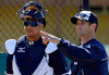 Detroit Tigers manager Brad Ausmus, right, talks with Victor Martinez before a bullpen session on the team’s first day of spring training for pitchers and catchers Friday in Lakeland, Fla. (AP Photo/Gene J. Puskar)