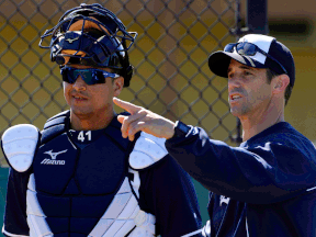 Detroit Tigers manager Brad Ausmus, right, talks with Victor Martinez before a bullpen session on the team's first day of spring training for pitchers and catchers Friday in Lakeland, Fla. (AP Photo/Gene J. Puskar)