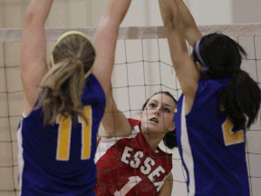 St. Anne's Kaila Crough, left, blocks a shot by Jordy Tytgat of Essex in 2011. Crough led the Saints to the girls volleyball title Friday night. (JASON KRYK/The Windsor Star)