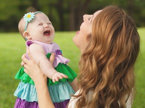 Tara McCallan, formerly of Windsor, laughs with her daughter Pip, who has Down Syndrome, and is the inspiration for her website Happy Soul Project. (Courtesy of the McCallan family)