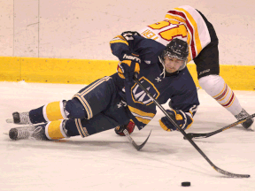 Windsor's Spencer Pommells, bottom, is checked by Guelph's Philip Teri. (DAN JANISSE/The Windsor Star)