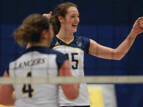 Windsor's Kaila Seguin, right, and Jessica Shepley celebrate against the Brock Badgers in women's volleyball at the St. Denis Centre. (DAX MELMER/The Windsor Star)