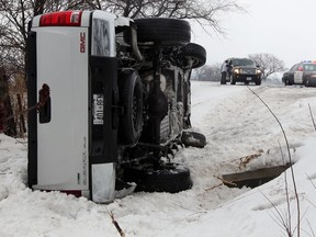 A GMC Sierra pickup rolled into the eastbound ditch of County Road 22 near Patillo Road February 20, 2014. OPP were on hand to assist and the occupants escaped unharmed. (NICK BRANCACCIO/The Windsor Star)