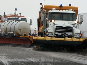 A pair of snowplows clear the way for traffic on eastbound lanes of Highway 401 at the 37 km marker February 20, 2014. (NICK BRANCACCIO/The Windsor Star)