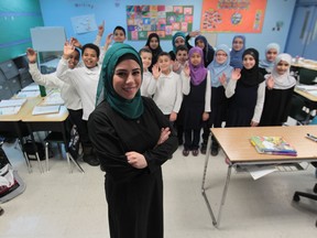 Louay El-Chami, a teacher at  An-Noor Private School in Windsor, is all smiles on Monday, Feb. 3, 2014, along with Grade 4 students who wrote the EQAO testing last year that helped earn the school top honours in the  top-ranking in Ontario in the Fraser Institute's report card on school performance. (JASON KRYK/The Windsor Star)