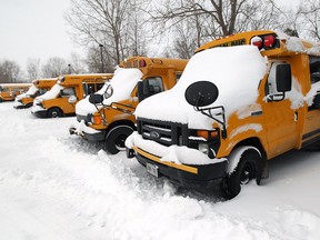 Idle school buses sit in a storage yard in West Windsor on Wednesday, February 5, 2014. School buses were cancelled despite schools being open.                                 (TYLER BROWNBRIDGE/The Windsor Star)
