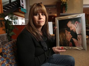 Michelle Marchand poses with a photo of herself and late husband Tim Marchand, Monday, Feb. 10, 2014, at the Windsor Regional Cancer Centre. At Tim's funeral donations were made towards Chairs Because We Care and she recently kicked in the rest of the funds needed to buy 10 new chairs for the waiting rooms near the radiation department. (DAN JANISSE/The Windsor Star)