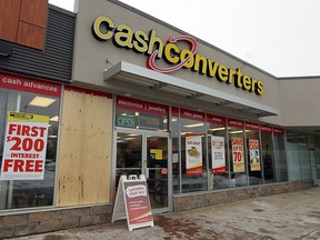 A sheet of plywood covers a broken window at Cash Converters in Windsor on Tuesday, February 4, 2014.                                 (TYLER BROWNBRIDGE/The Windsor Star)