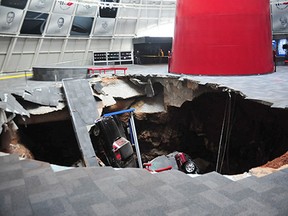 This image provided by the National Corvette Museum shows several cars that collapsed into a sinkhole Wednesday, Feb. 12, 2014, in Bowling Green, Ky. The museum said a total of eight cars were damaged when a sinkhole opened up inside the museum. (AP Photo/National Corvette Museum, HO)