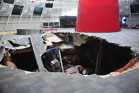 This image provided by the National Corvette Museum shows several cars that collapsed into a sinkhole Wednesday, Feb. 12, 2014, in Bowling Green, Ky. The museum said a total of eight cars were damaged when a sinkhole opened up inside the museum. (AP Photo/National Corvette Museum, HO)
