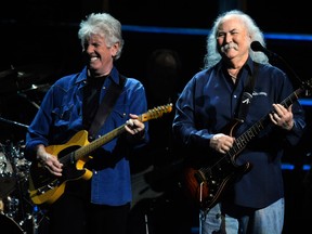 In this Oct. 2009 file photo, Graham Nash, left, and David Crosby of Crosby, Stills, and Nash perform at the 25th Anniversary Rock & Roll Hall of Fame concert at Madison Square Garden, in New York. Crosby has undergone heart surgery and he's postponing sold-out California shows. Publicist Michael Jensen tells City News Service on Monday, Feb. 17, 2014, that the 72-year-old Crosby had a cardiac catheterization last week to fix a blocked coronary artery. (AP Photo/Henny Ray Abrams, file)