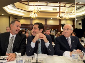 In this file photo, Bell Canada CEO George Cope, left, chats with Bell's Chief L:egal Officer Mirko Bibic, centre, as Astral CEO Ian Greenberg looks on before the start of the Canadian Radio-Television and Telecommunication Commission hearings into the Astral-Bell merger Monday, May 6, 2013 in Montreal. (THE CANADIAN PRESS/Ryan Remiorz)