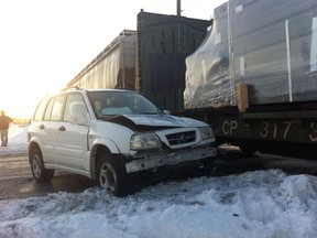 Only minor injuries are reported after an SUV collided with a freight train at Randolph and College Avenues in west Windsor. (TwitPic: Dan Janisse/The Windsor Star)