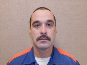 This Feb. 11, 2013 photo provided by the Michigan Department of Corrections shows Michael David Elliot. Elliot, who is serving life behind bars for murder in four 1993 deaths in Michigan, has escaped from prison and may have abducted a woman before she got away in Indiana, according to officials. Michigan Department of Corrections spokesman Russ Marlan says in an email that 40-year-old Elliot was discovered missing about 9:30 p.m. Sunday, Feb. 2, 2014, from the Ionia Correctional Facility in mid-Michigan. (AP Photo/Michigan Department of Corrections)