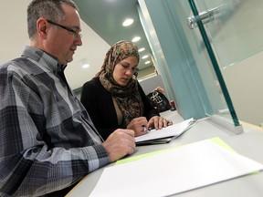 Remy Boubol files her election papers with Chuck Scarpelli, manager of records and elections, at city hall in Windsor on Wednesday, February 19, 2014. Boubol is the first woman to enter the race for city council.                (TYLER BROWNBRIDGE/The Windsor Star)